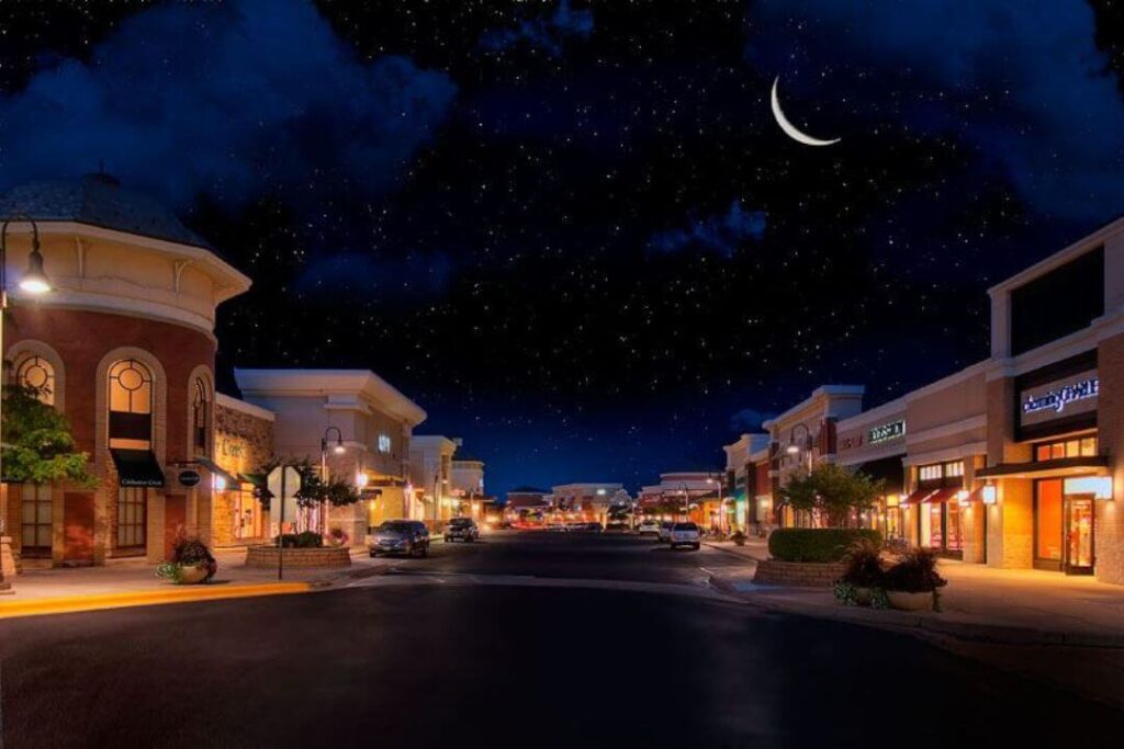 Woodbury Town Center at night under a starry sky, highlighting a beautiful environment for moving help in Woodbury MN.