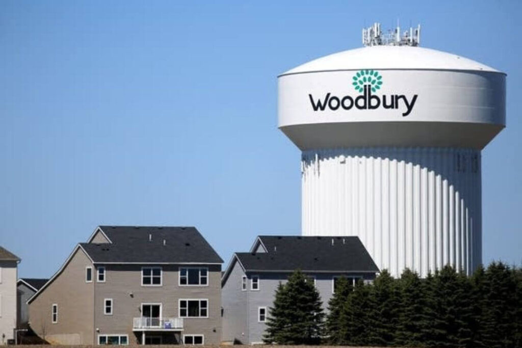 The iconic Woodbury, MN water tower surrounded by suburban homes, showcasing the perfect spot for moving help in Woodbury MN.