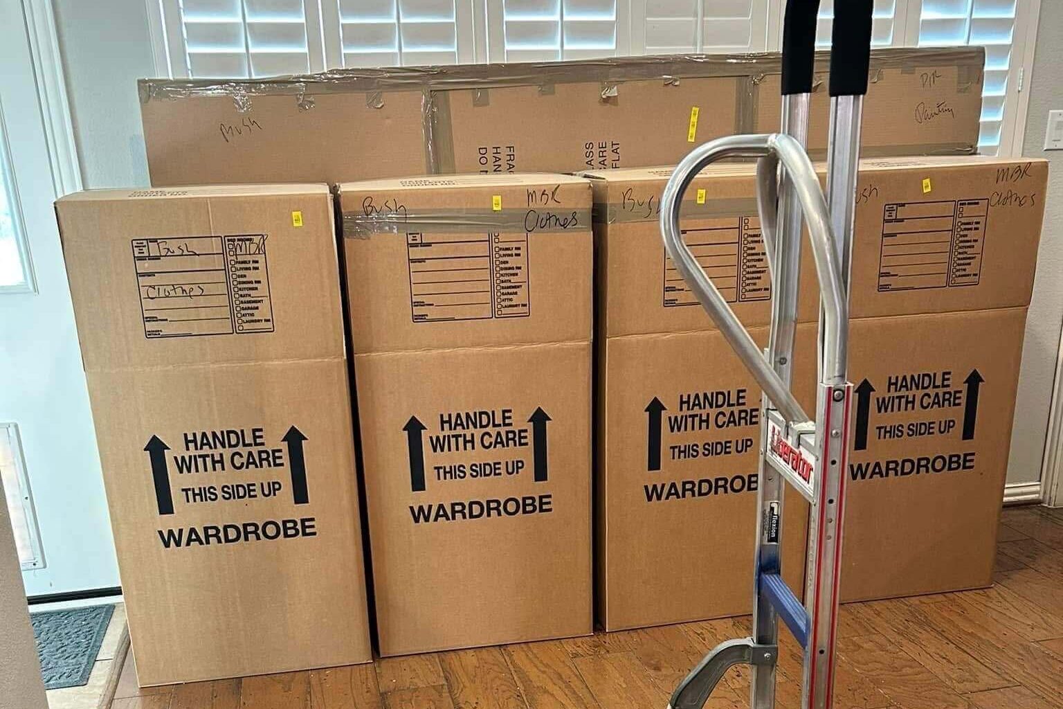Wardrobe moving boxes and a hand truck in a Minneapolis home, perfect for packing clothes and household essentials.