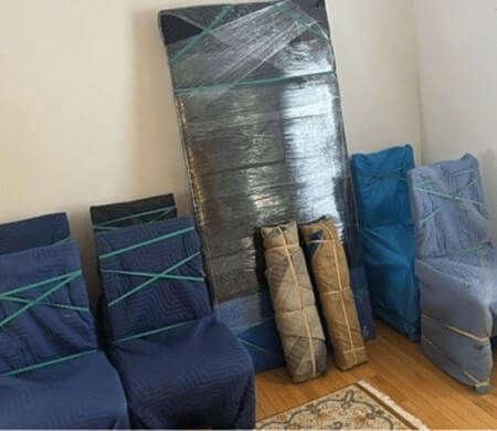 Wrapped furniture prepared for transport by EZ Breezy Movers, experienced furniture movers serving Minnehaha Woods in Minneapolis, MN.