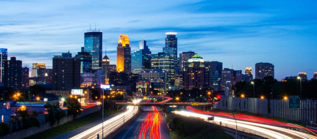 Minneapolis skyline at dusk viewed from I-94, captured for EZ Breezy Movers, trusted Minneapolis movers serving local and long-distance moves.